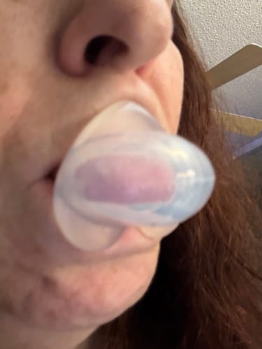 Customer photo of the SnoreGrip Pro silicone device held in a hand